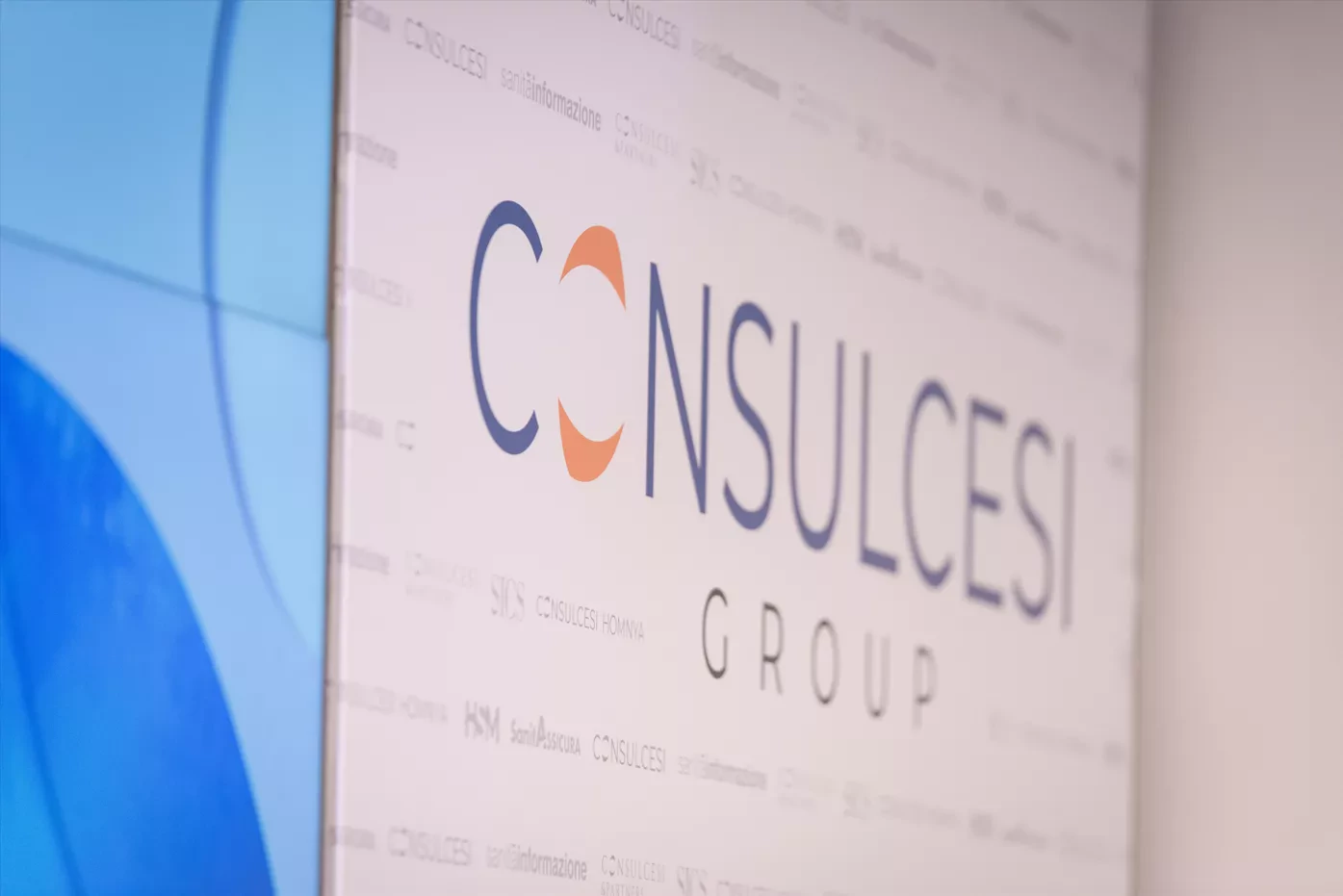 Consulcesi Group logo on a corporate wall, representing one of Europe’s largest healthcare professional networks.