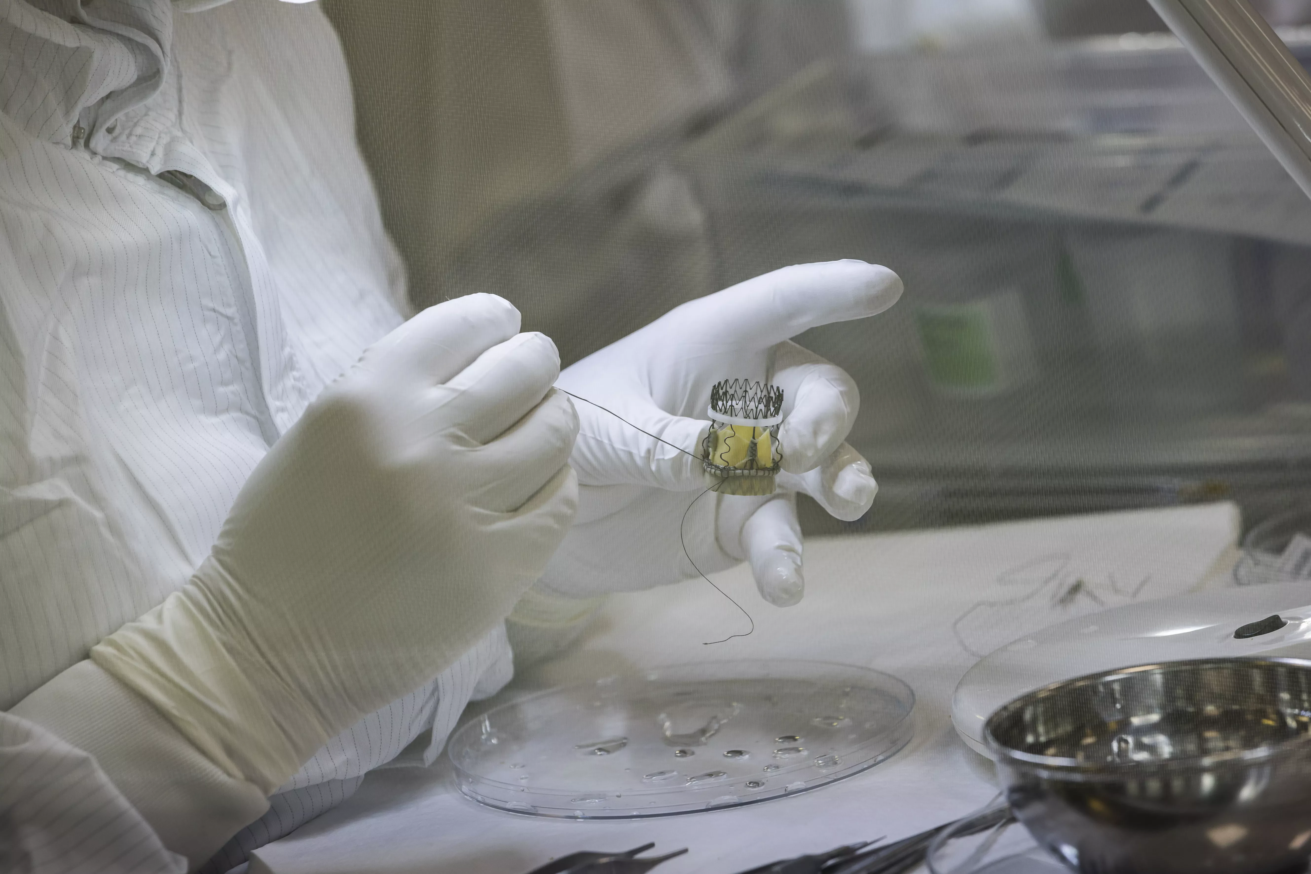 Technician working on a prosthetic heart valve, part of Corcym’s structural heart disease solutions.